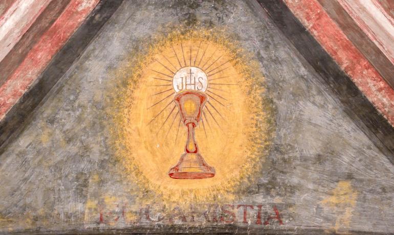 Affresco religioso con calice e ostia.